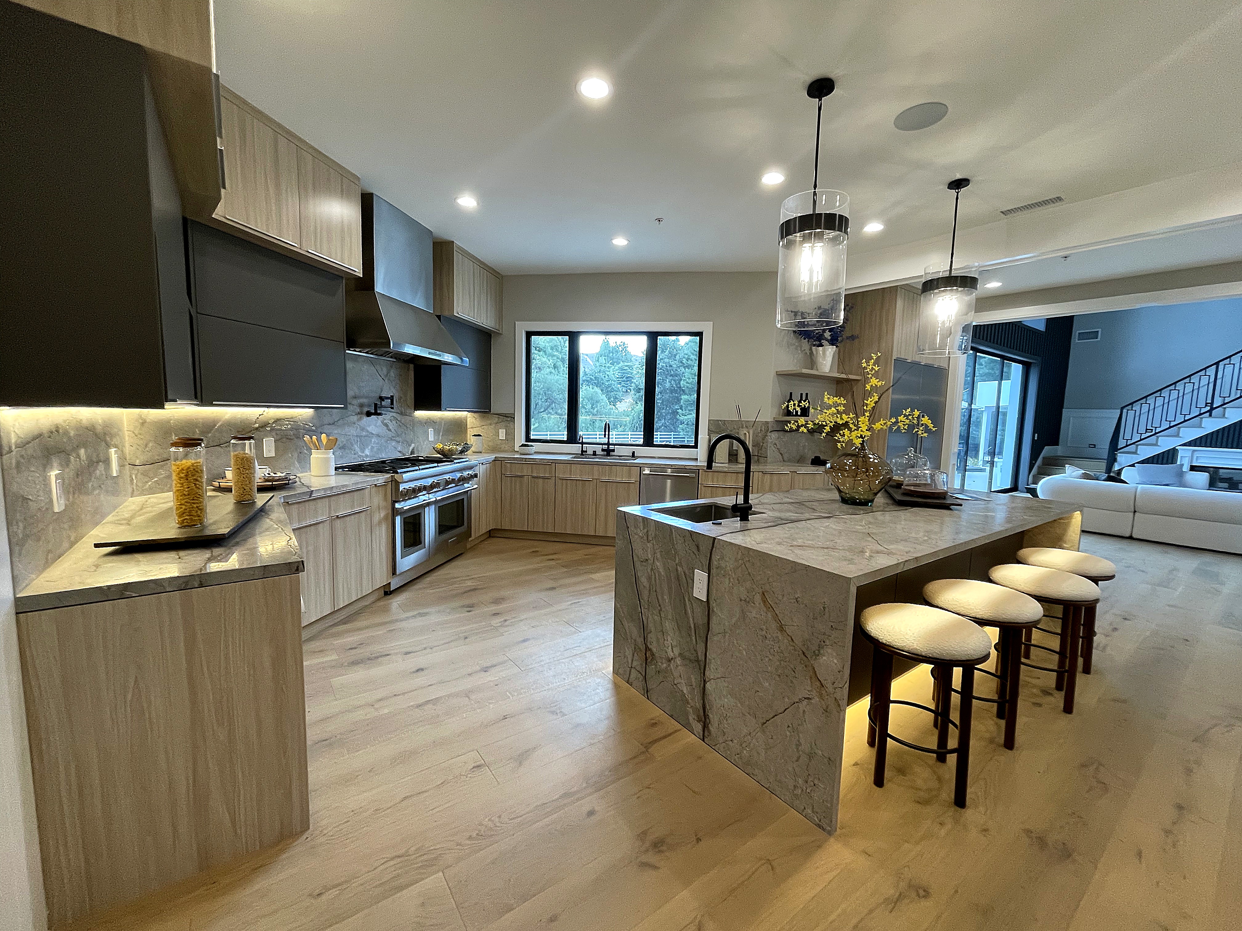 Finished kitchen with marble waterfall island at an Agoura Hills residence